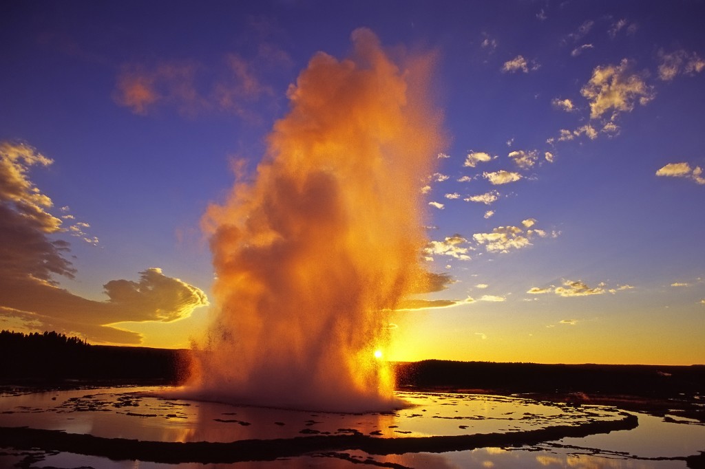 Great Fountain Geyser in Yellowstone National Park is lit by the sun, giving it an orange glow. (photo ©Leon Jenson ÑÊclick to enlarge)